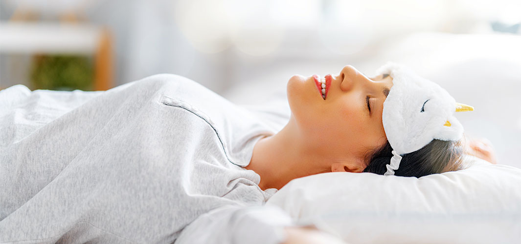 Beautiful young woman is sleeping in the bedroom at home.
