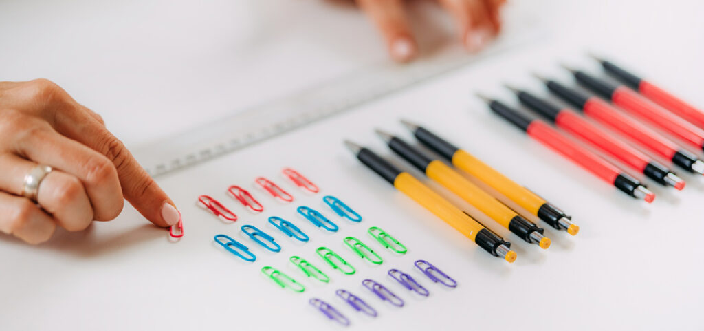 Person obsessively organizing office supplies due to OCD